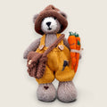 Alder Finch handmade collectible knitted bear wearing mustard dungarees and carrying needle-felted carrots.