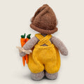 Back view of Alder Finch handmade collectible knitted bear showing knitted dungarees and knitted pointed hat.