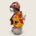 Left Side view of Alder Finch handmade collectible knitted bear showing knitted satchel and pointed hat.
