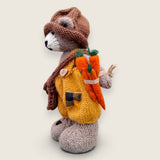 Left Side view of Alder Finch handmade collectible knitted bear showing knitted satchel and pointed hat.