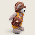 Right Side view of Alder Finch handmade collectible knitted bear showing knitted satchel and pointed hat.