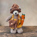 Alder Finch, a handmade Pebblewood collectible bear with knitted hat, dungarees, satchel and needle-felted carrot accessories.