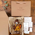 Alder Finch Pebblewood collectible bear presented in kraft packaging with Certificate of Authenticity, Resident Card and care details.