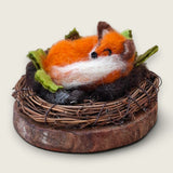 The full piece from an angled view, showing the fox, wreath and wood slice together