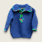 Handknitted blue alpaca and wool baby jumper with colourful tartan trim and green buttons, handmade in the Boyne Valley, Ireland.