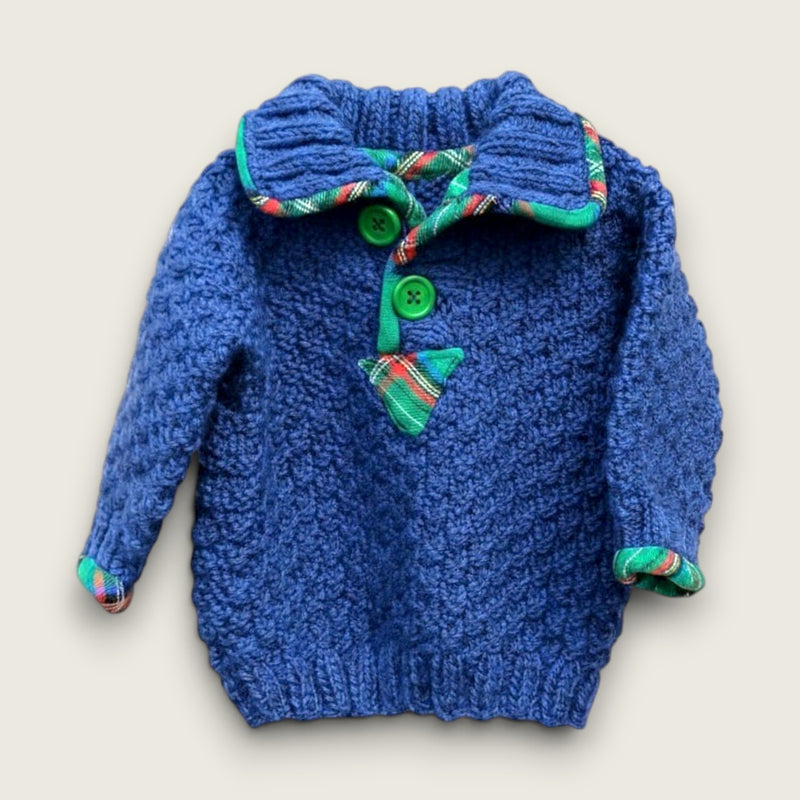 Handknitted blue alpaca and wool baby jumper with colourful tartan trim and green buttons, handmade in the Boyne Valley, Ireland.