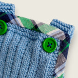 Blue merino baby dungarees showing green buttons and printed tartan trim.