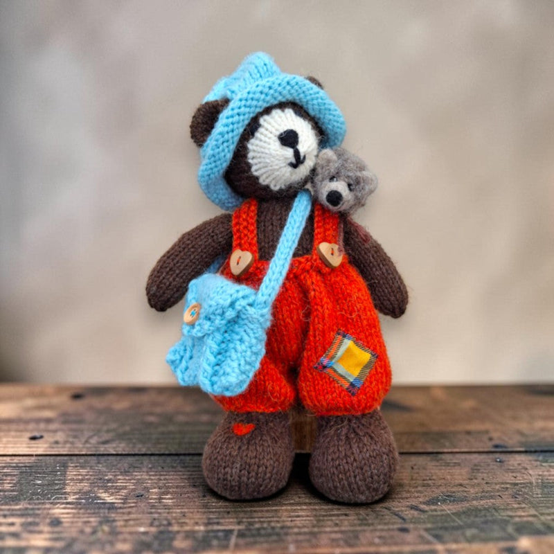 Bracken Moss, a handmade Pebblewood collectible bear, displayed with his knitted accessories and needle-felted hedgehog companion.