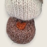 Close-up of Bramble Rowan's needle-felted heart on the right paw.