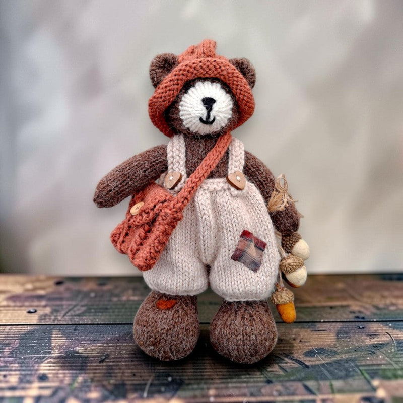 Bramble Rowan, a handmade Pebblewood collectible bear with knitted hat, dungarees, satchel and needle-felted acorn accessories.