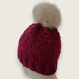 Back view of the burgundy hat, showing the textured stitch and pompom