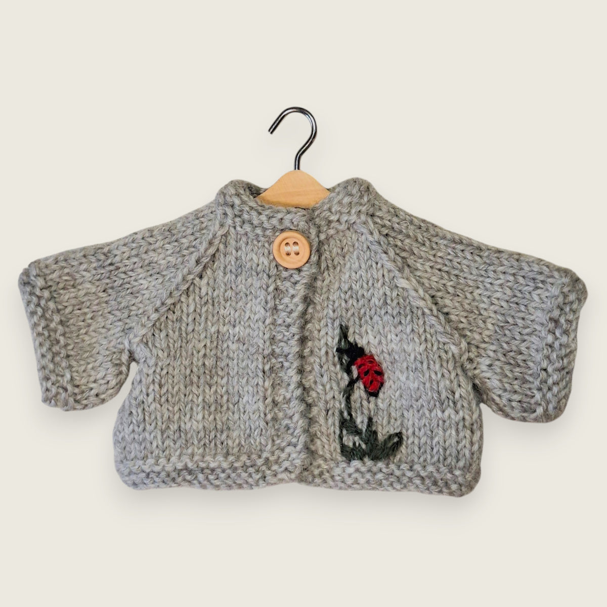 Light grey wool cardigan for collectible bear with embroidered ladybird