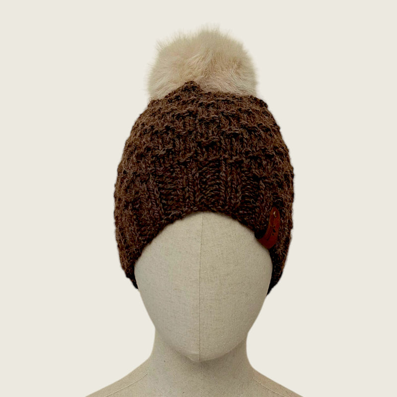 Dark brown handknitted alpaca and wool hat with a mink-coloured faux fur pompom, front view