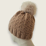 Back view of the fawn hat, showing the textured stitch and pompom