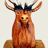 Close view of the carved stag's face and the chisel marks in the lime wood