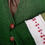 Green merino toddler cardigan with red heart knit detail and wooden buttons