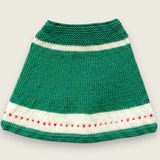 Back view of green merino wool capelet with ivory bands and red heart detail