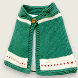 Front view of green merino wool capelet with red intarsia heart detail