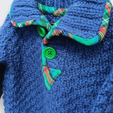 Hand knitted blue alpaca wool baby jumper close up showing original tartan trim collar and green button detail - handmade by The Crafty Pebblers Ireland