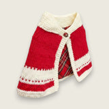 Side view of red and ivory handknitted merino wool baby capelet.