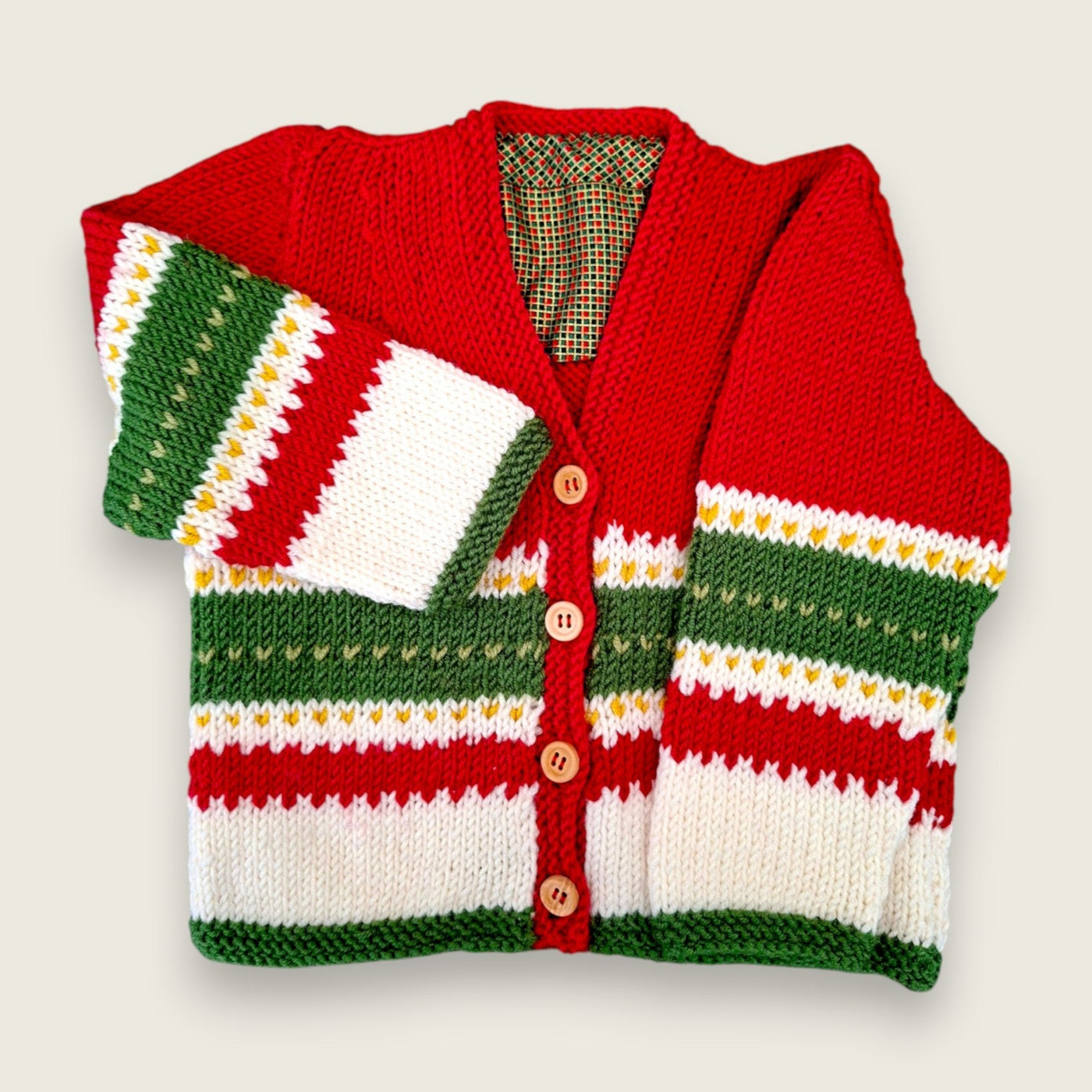Handknitted red, green and white merino wool baby cardigan