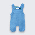 Hand knitted pale blue merino wool baby dungarees full back view showing tartan trim across back straps -handmade in Co. Meath Ireland
