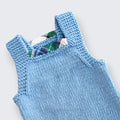 Close up of green and navy tartan trim detail on back straps of hand knitted merino baby dungarees - The Crafty Pebblers, Boyne Valley Ireland
