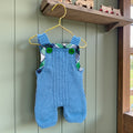 Hand knitted pale blue merino baby dungarees lifestyle shot - merino wool knitwear handmade in the Boyne Valley Co. Meath Ireland by The Crafty Pebblers
