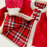 Close-up of tartan lining and ecru trim on red merino baby coat