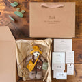 Hazel Hollow Pebblewood collectible bear with kraft packaging, Certificate of Authenticity, Resident Card and care details.