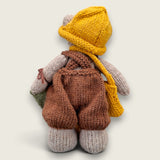 Back view of Hazel Hollow Pebblewood collectible bear showing his hand-knitted brown dungarees, mustard hat and satchel.