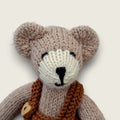 Close-up of Hazel Hollow showing the individually finished face of the hand-knitted Pebblewood collectible bear.