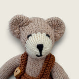 Close-up of Hazel Hollow showing the individually finished face of the hand-knitted Pebblewood collectible bear.