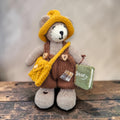Hazel Hollow, the Pebblewood Story Keeper, displayed with his hand-knitted clothing, satchel and needle-felted book of stories.
