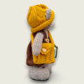 Right side view of Hazel Hollow, Pebblewood Story Keeper, showing his hand-knitted clothing and needle-felted book of stories.