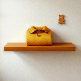 Mustard alpaca and wool children's jumper in a natural nursery setting.