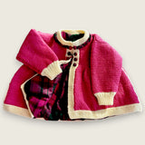 Magenta merino baby matinee coat showing printed tartan lining