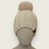 Natural handknitted alpaca and wool hat with a mink-coloured faux fur pompom, front view
