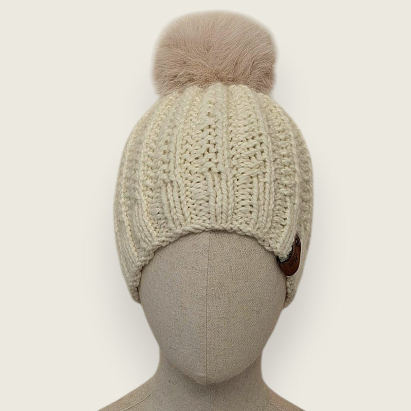 Natural handknitted alpaca and wool hat with a mink-coloured faux fur pompom, front view