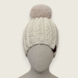 Natural handknitted alpaca and wool hat with a mink-coloured faux fur pompom, front view