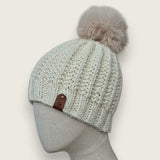 Side view of the natural false rib hat on a mannequin, showing the leatherette tag
