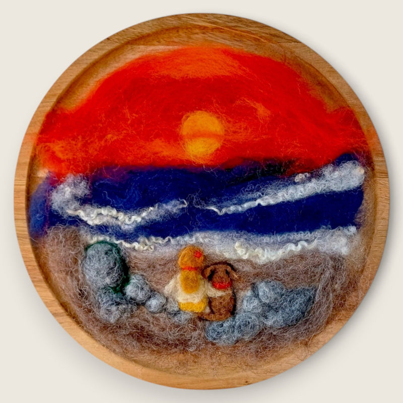 Needle felted wool picture of a girl and her dog watching the sunset on a beach, handmade in Ireland.
