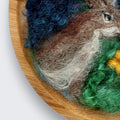Needle felted wool picture of two rabbits under the moon showing natural wood grain of round wooden plate mount - handmade in Co. Meath Ireland