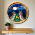 Needle felted wool picture of two rabbits under the moon displayed in home interior - handmade Irish fibre art by The Crafty Pebblers