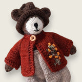 Close view of Pebblewood Resident wearing dark rust wool wildflower cardigan