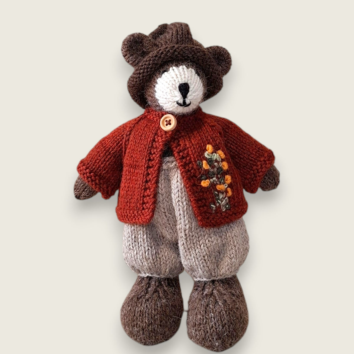 Pebblewood Resident wearing dark rust wool cardigan with hand embroidered wildflowers