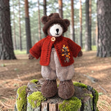 Pebblewood Resident wearing dark rust wildflower cardigan in a woodland setting