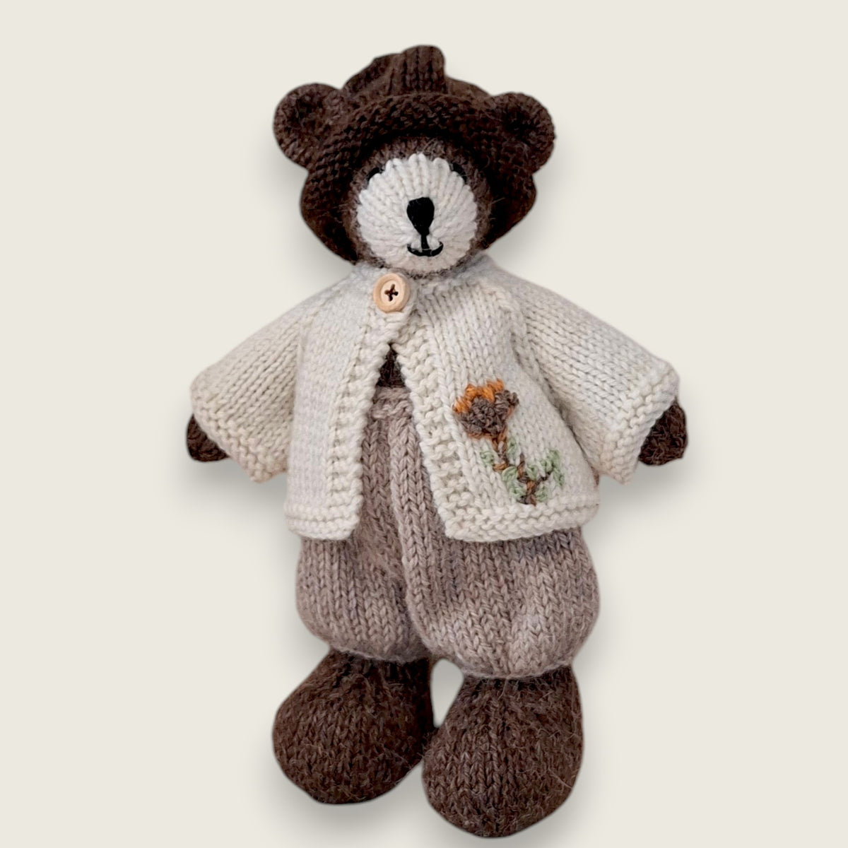 Pebblewood Resident wearing ecru wool cardigan with embroidered flower