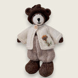 Pebblewood Resident wearing ecru wool cardigan with embroidered flower