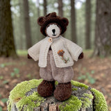 Pebblewood Resident wearing ecru embroidered wool cardigan in woodland